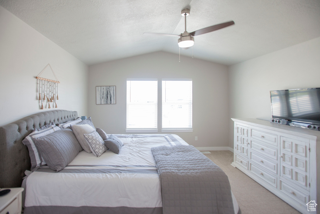 Bedroom with light carpet, lofted ceiling, and ceiling fan