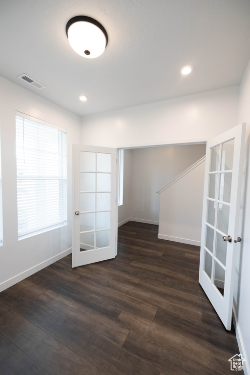 Unfurnished room with french doors and dark hardwood / wood-style flooring