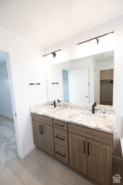 Bathroom with tile flooring and dual vanity