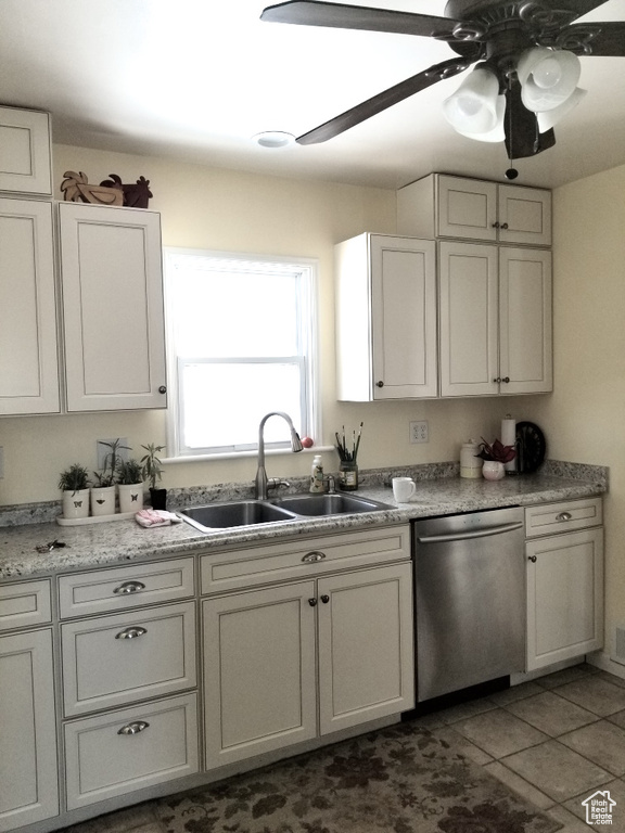Kitchen with ceiling fan, white cabinetry, dishwasher, sink, and tile floors