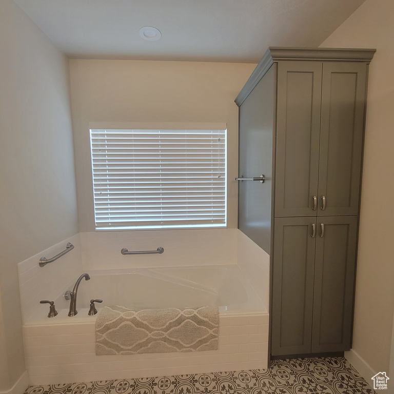 Bathroom featuring tile flooring and a bathtub