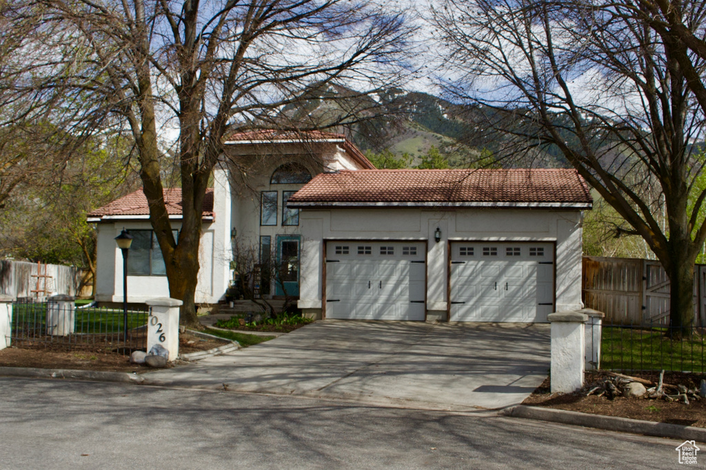 Mediterranean / spanish home featuring a garage and a mountain view