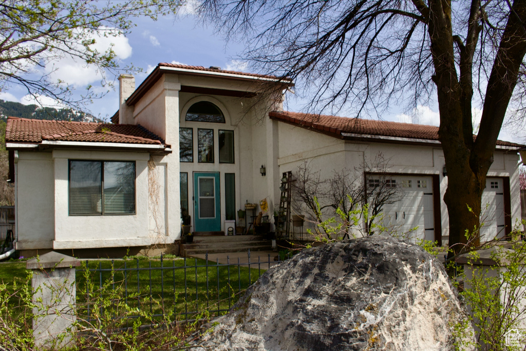 Mediterranean / spanish-style house with a garage