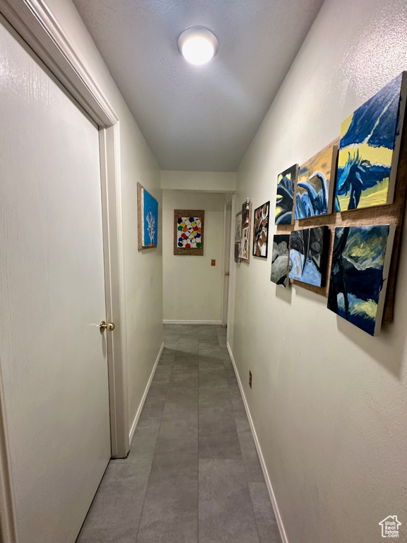 Corridor with dark tile flooring