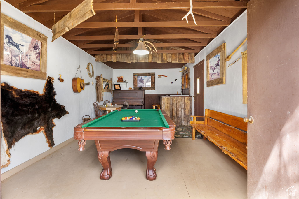 Rec room featuring concrete flooring, pool table, and vaulted ceiling with beams