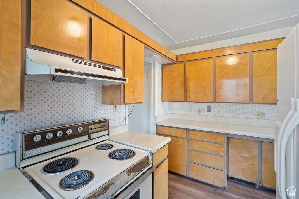 Kitchen featuring dark hardwood / wood-style floors and white appliances