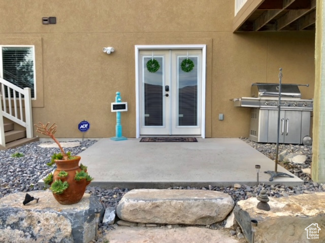 Doorway to property featuring french doors and a patio area