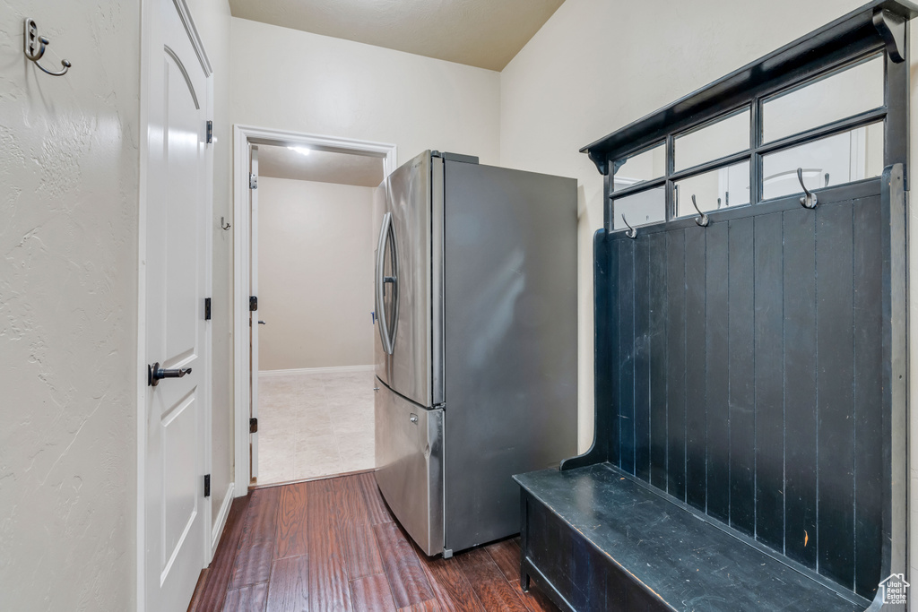 Interior space featuring dark hardwood / wood-style floors and stainless steel refrigerator