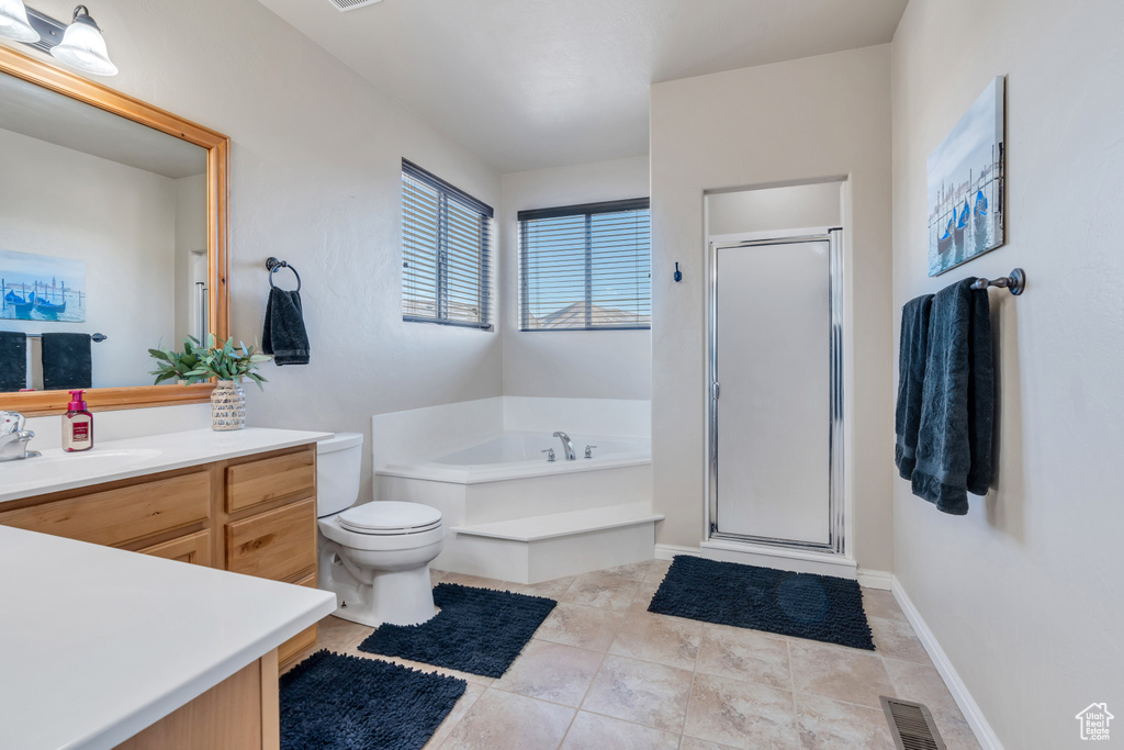 Full bathroom featuring independent shower and bath, toilet, tile flooring, and vanity
