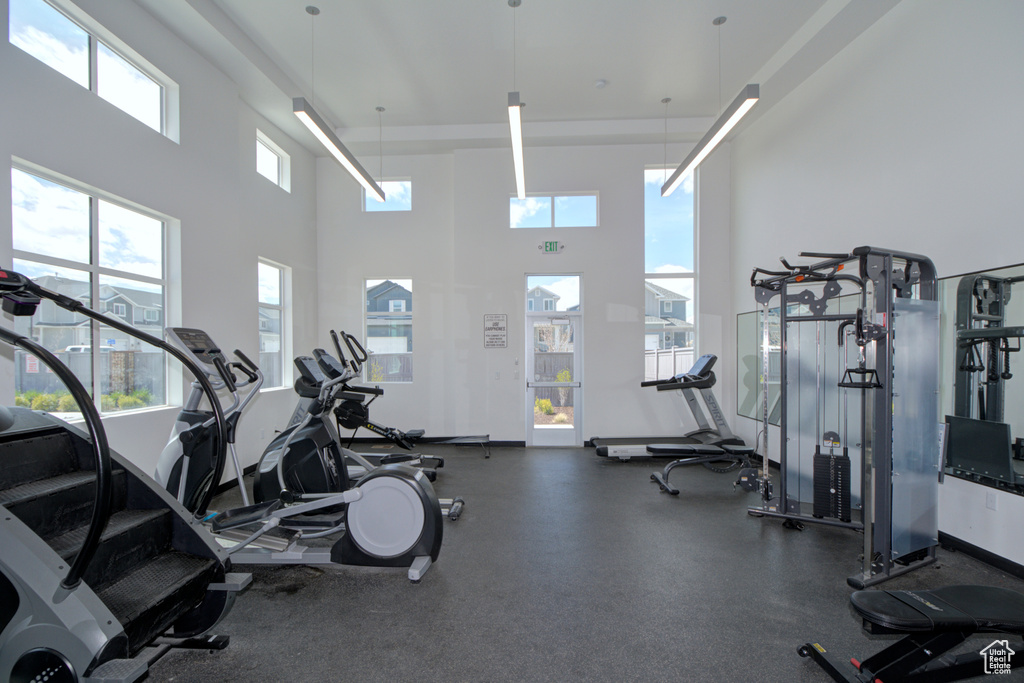 Exercise room featuring a towering ceiling
