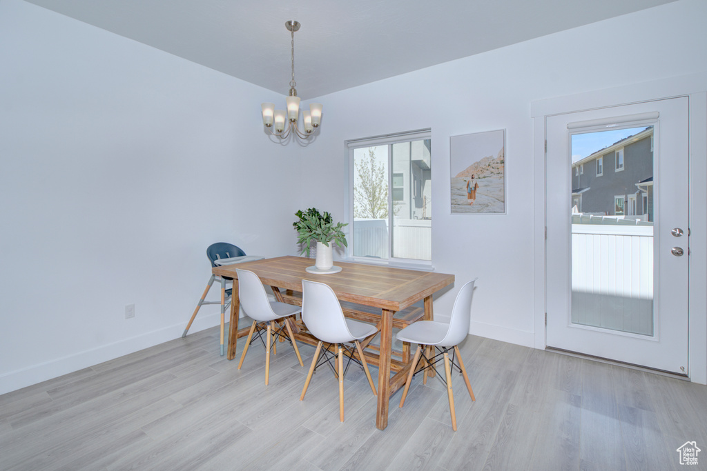 Dining space featuring light hardwood / wood-style flooring and a chandelier