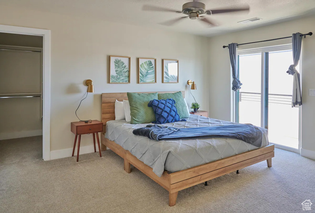 Bedroom featuring light colored carpet, a closet, and ceiling fan