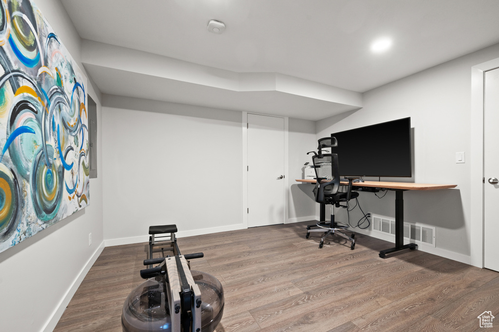 Exercise room featuring dark hardwood / wood-style flooring