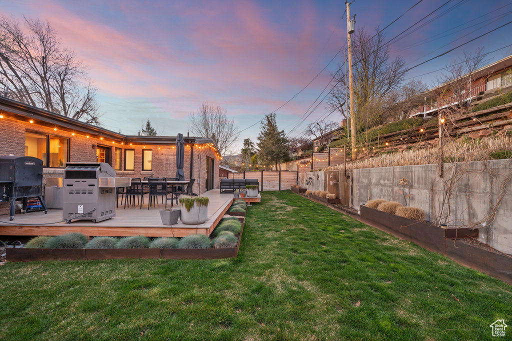 Yard at dusk with a wooden deck