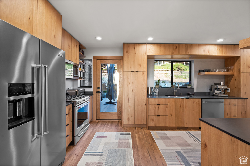 Kitchen featuring sink, appliances with stainless steel finishes, and light hardwood / wood-style flooring