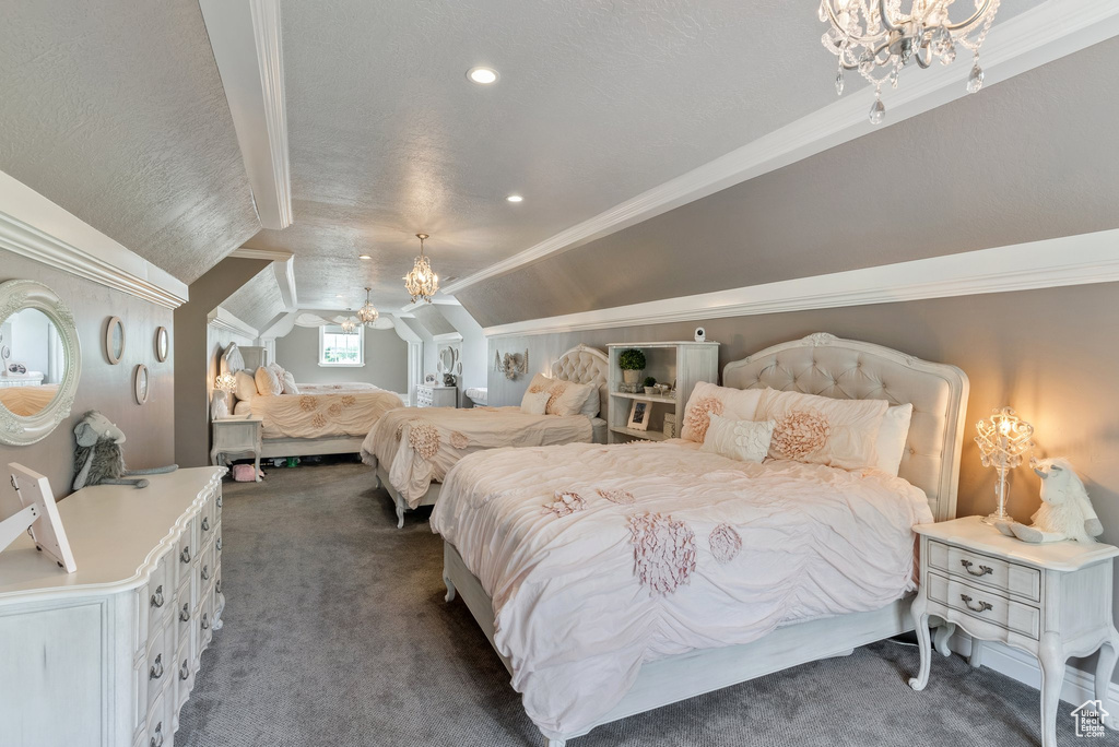 Bedroom featuring vaulted ceiling, dark carpet, a chandelier, and crown molding