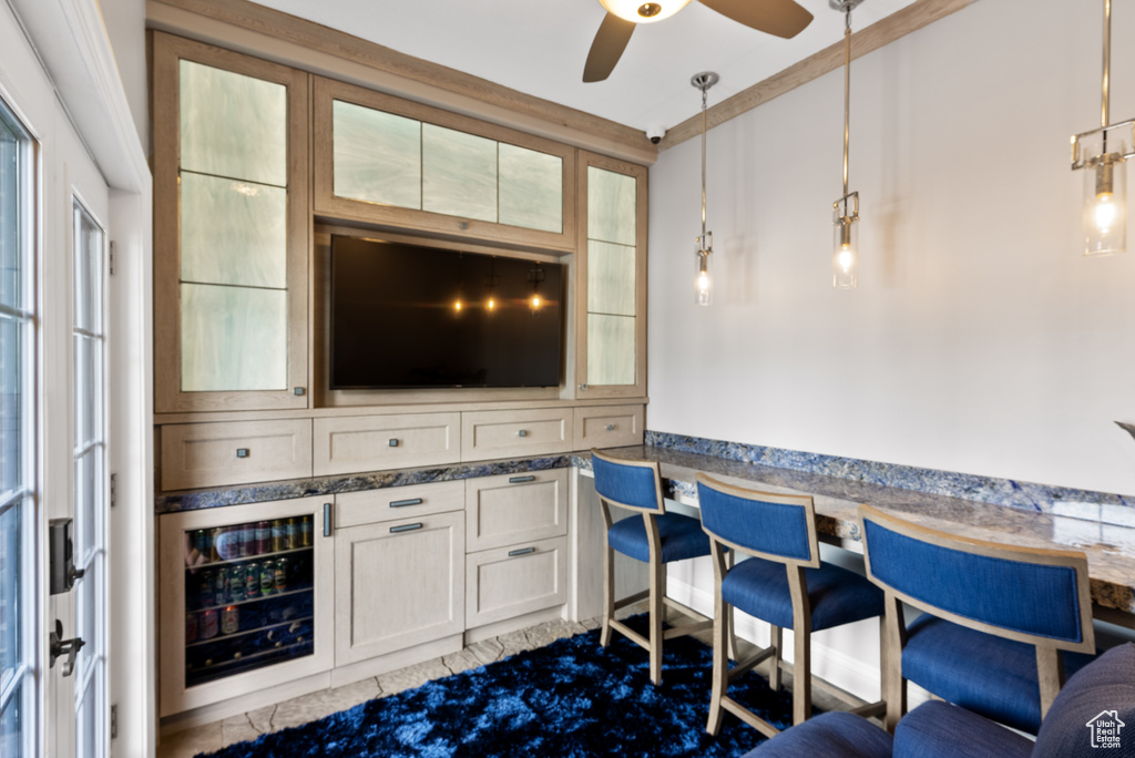Interior space with wine cooler and ceiling fan