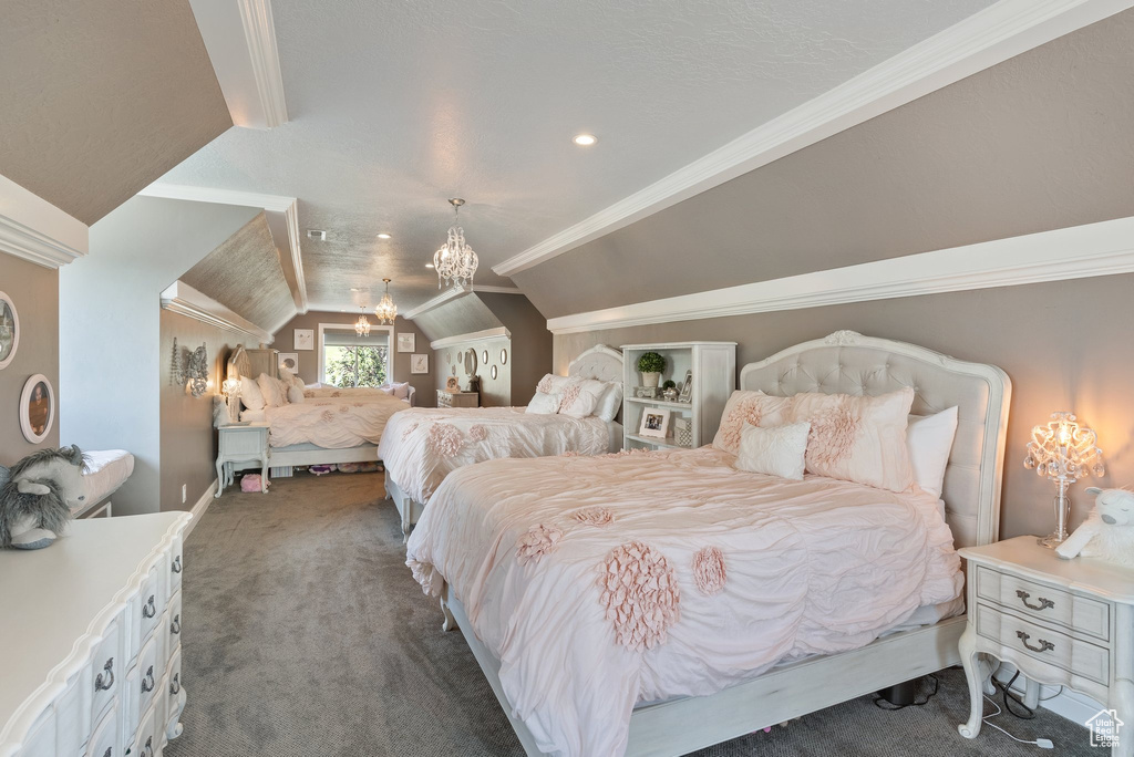 Carpeted bedroom with vaulted ceiling, crown molding, and a chandelier