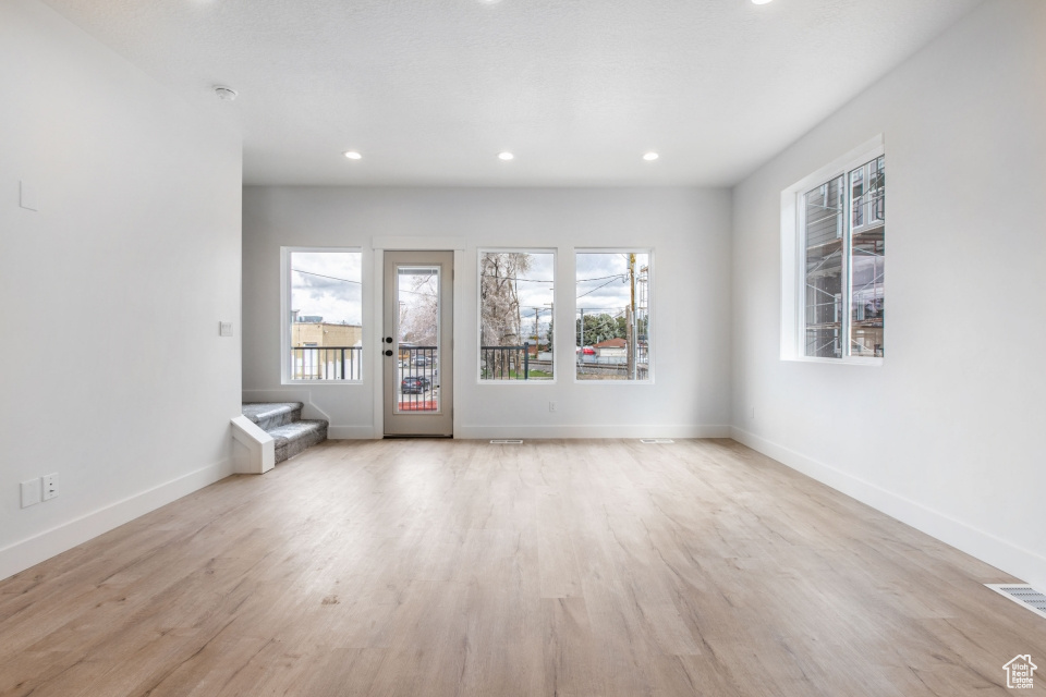Unfurnished room with light wood-type flooring