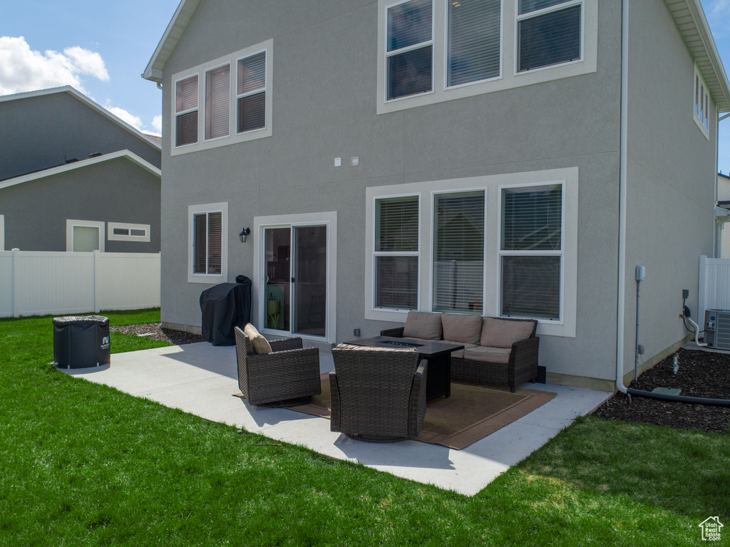 Rear view of property with a patio area, a yard, and an outdoor hangout area