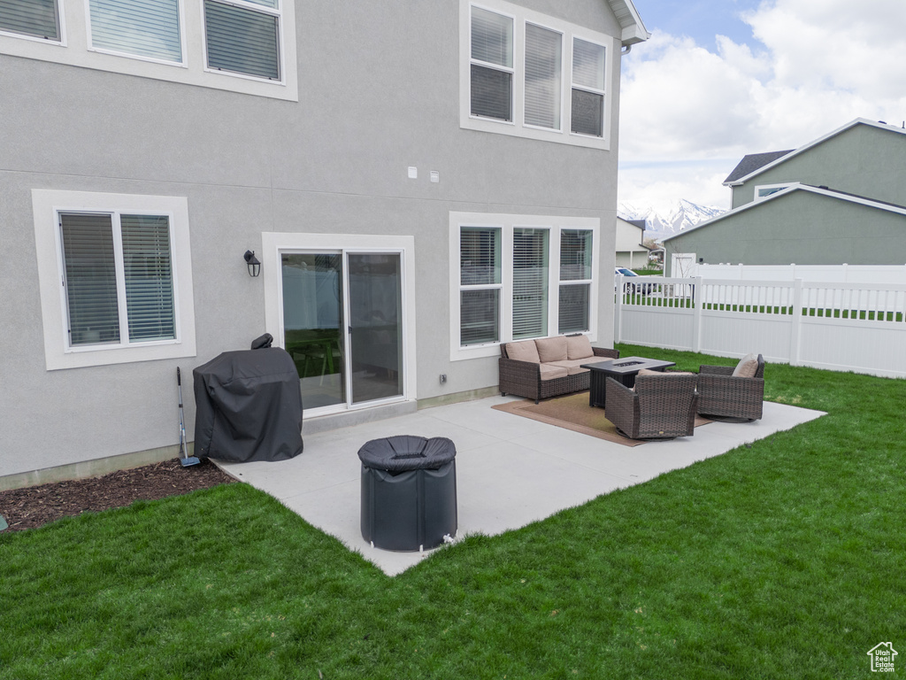 Back of property with a patio, outdoor lounge area, and a lawn