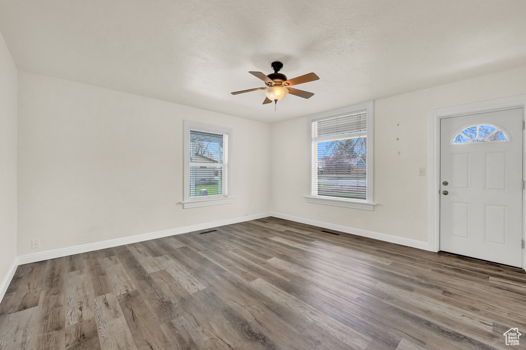Entryway with dark hardwood / wood-style floors and ceiling fan