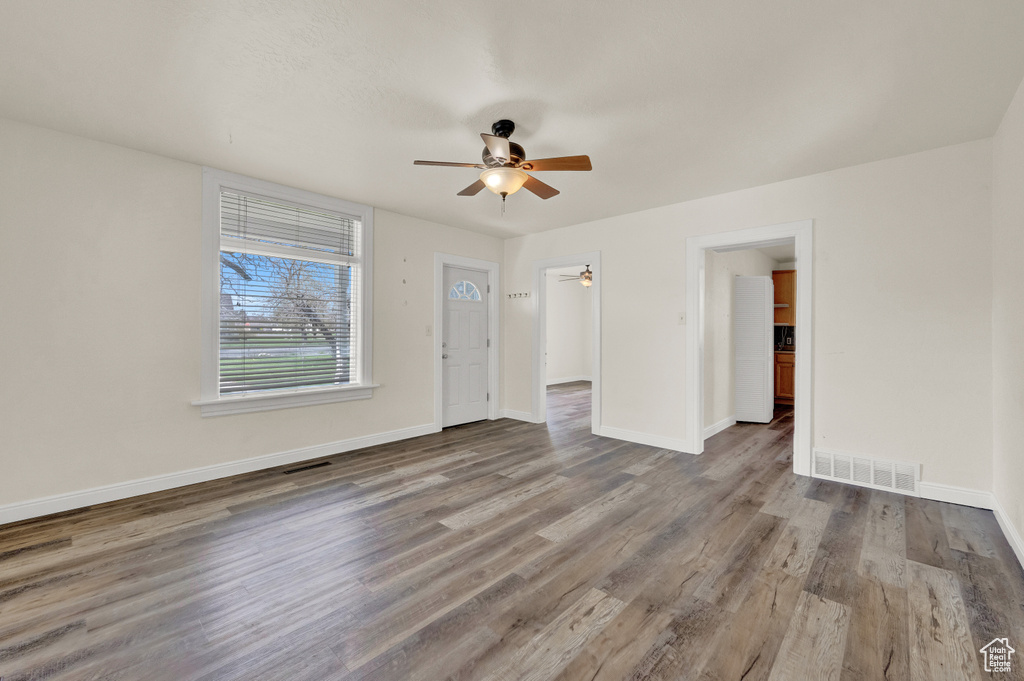Spare room featuring ceiling fan and dark hardwood / wood-style floors