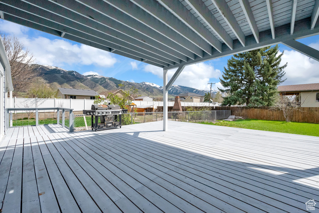 Deck featuring a mountain view and a yard