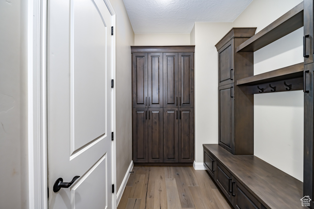 Mudroom featuring light hardwood / wood-style flooring and a textured ceiling