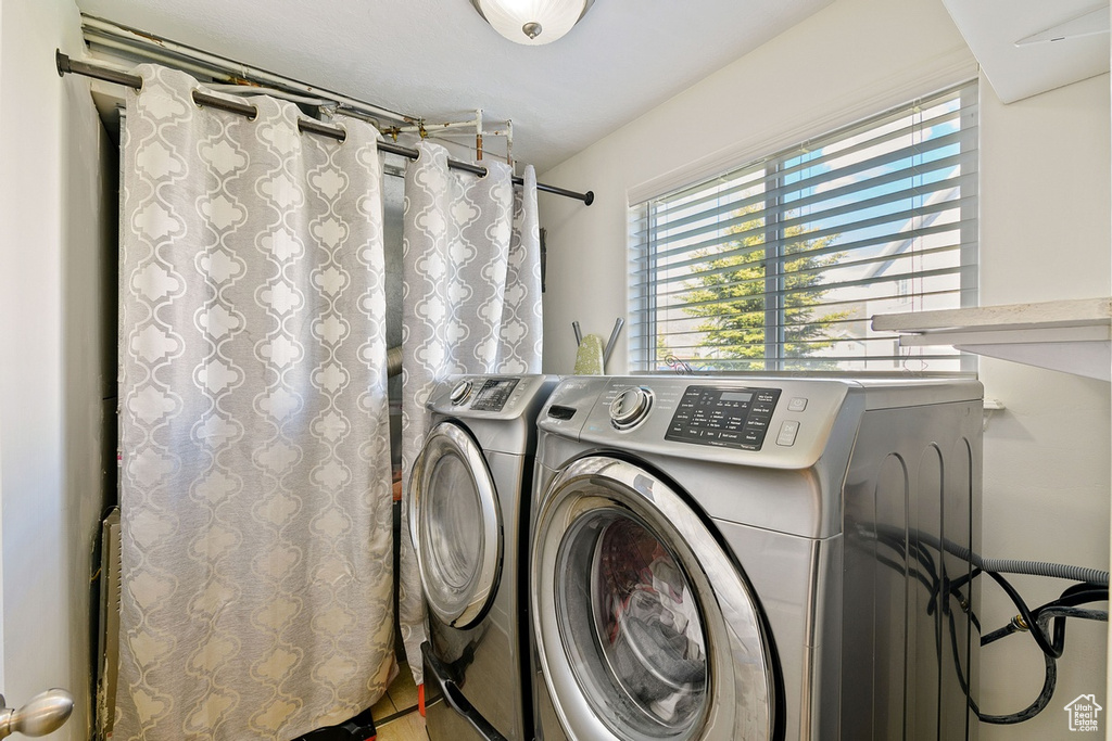 Laundry room with a healthy amount of sunlight and washing machine and dryer