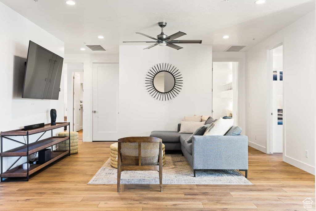 Living room featuring ceiling fan and light hardwood / wood-style floors