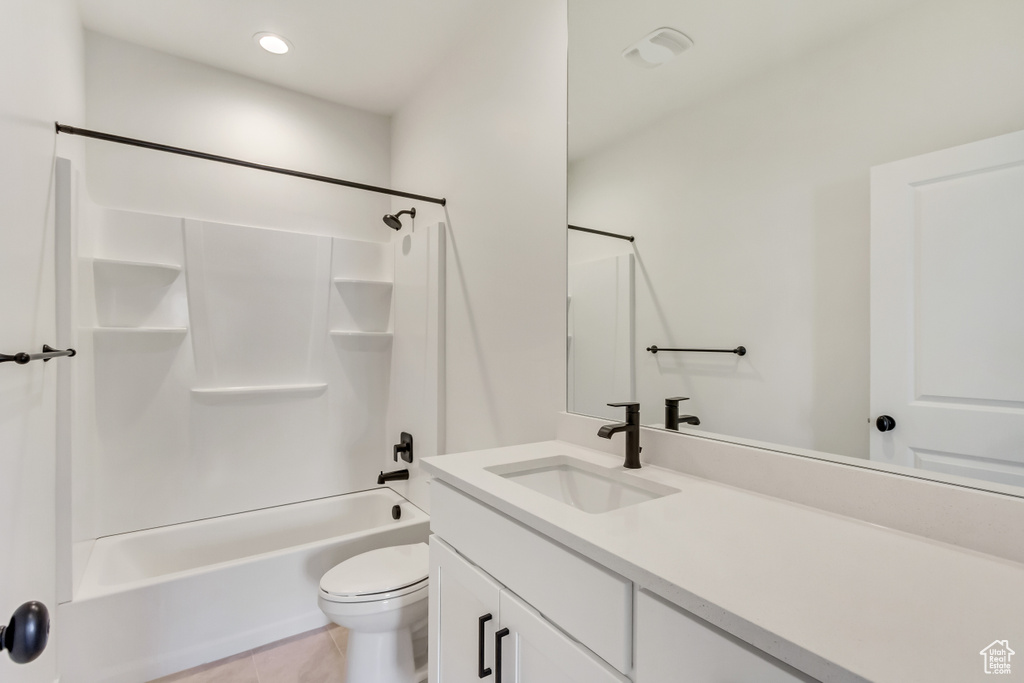 Full bathroom featuring washtub / shower combination, vanity, toilet, and tile floors