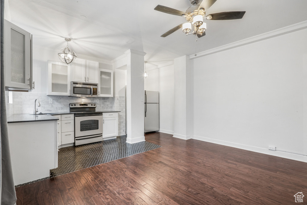 Kitchen featuring ceiling fan, white cabinets, white appliances, tasteful backsplash, and dark hardwood / wood-style floors