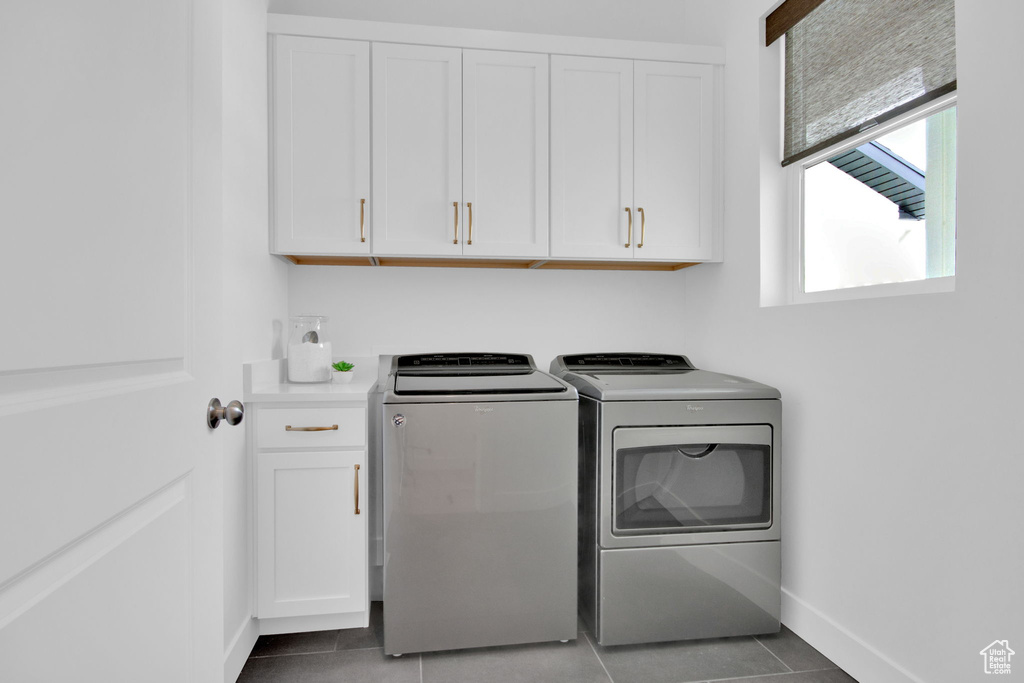 Laundry room featuring cabinets, independent washer and dryer, and tile flooring