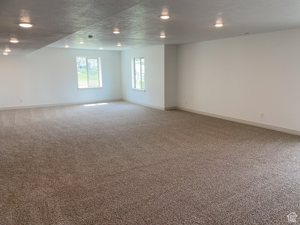 Spare room with a textured ceiling and carpet floors
