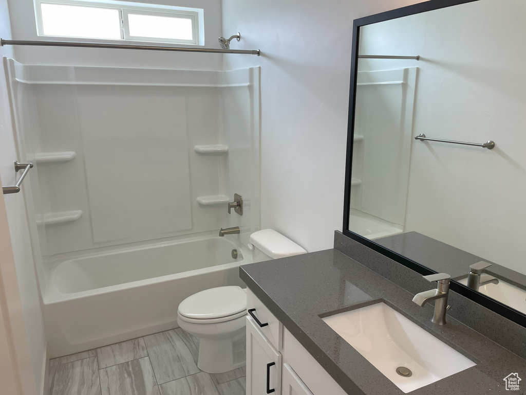 Full bathroom featuring oversized vanity,  shower combination, toilet, and tile flooring
