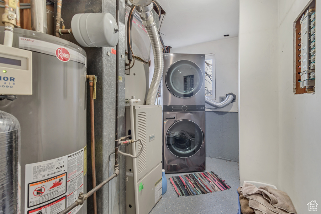 Laundry area with stacked washer / drying machine and gas water heater