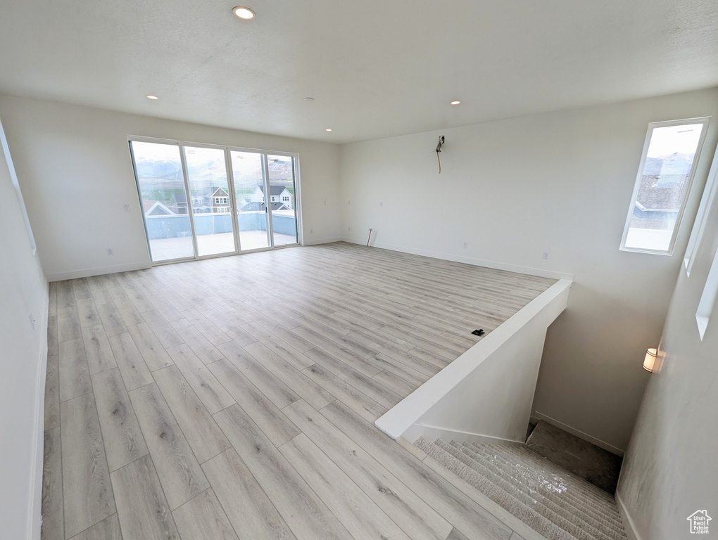 Empty room featuring a wealth of natural light and light hardwood / wood-style floors