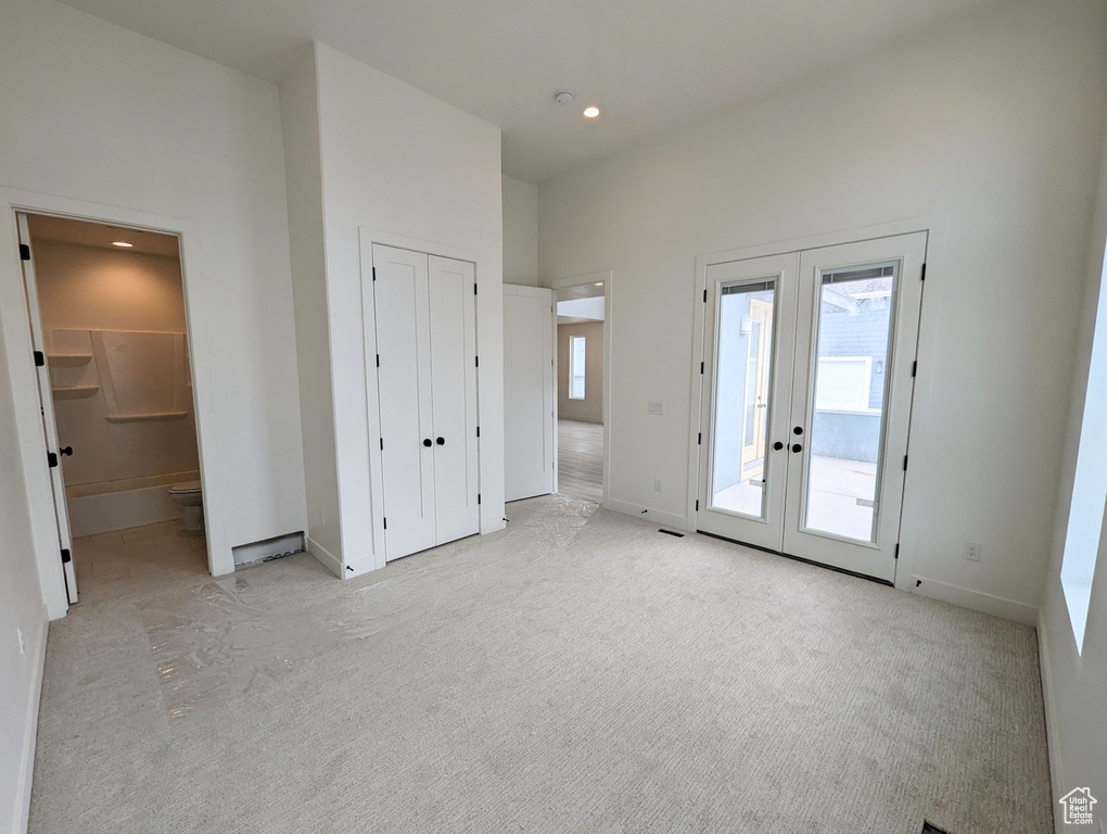 Interior space featuring french doors and light colored carpet