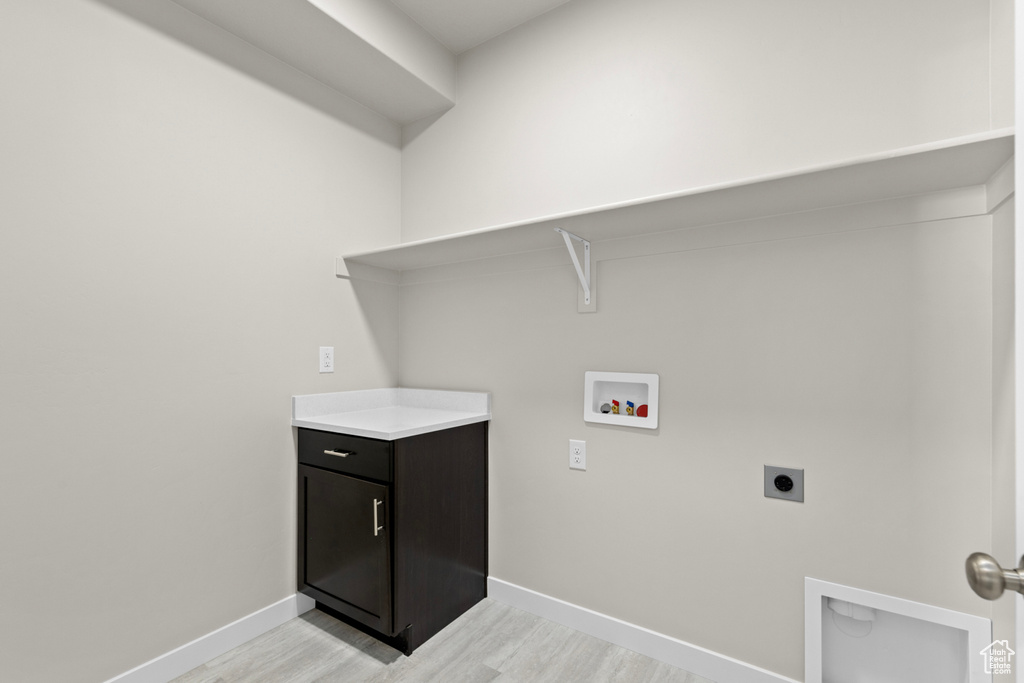 Washroom featuring washer hookup, light hardwood / wood-style flooring, and electric dryer hookup