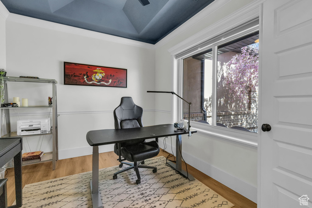 Office area with crown molding and light hardwood / wood-style floors
