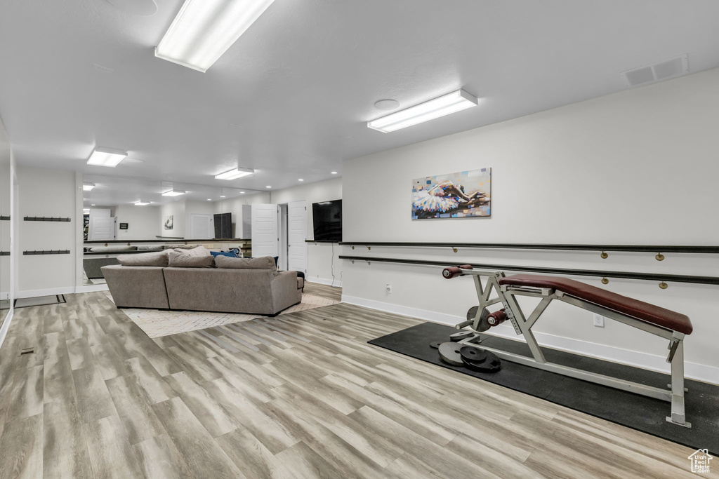 Exercise room featuring light hardwood / wood-style flooring