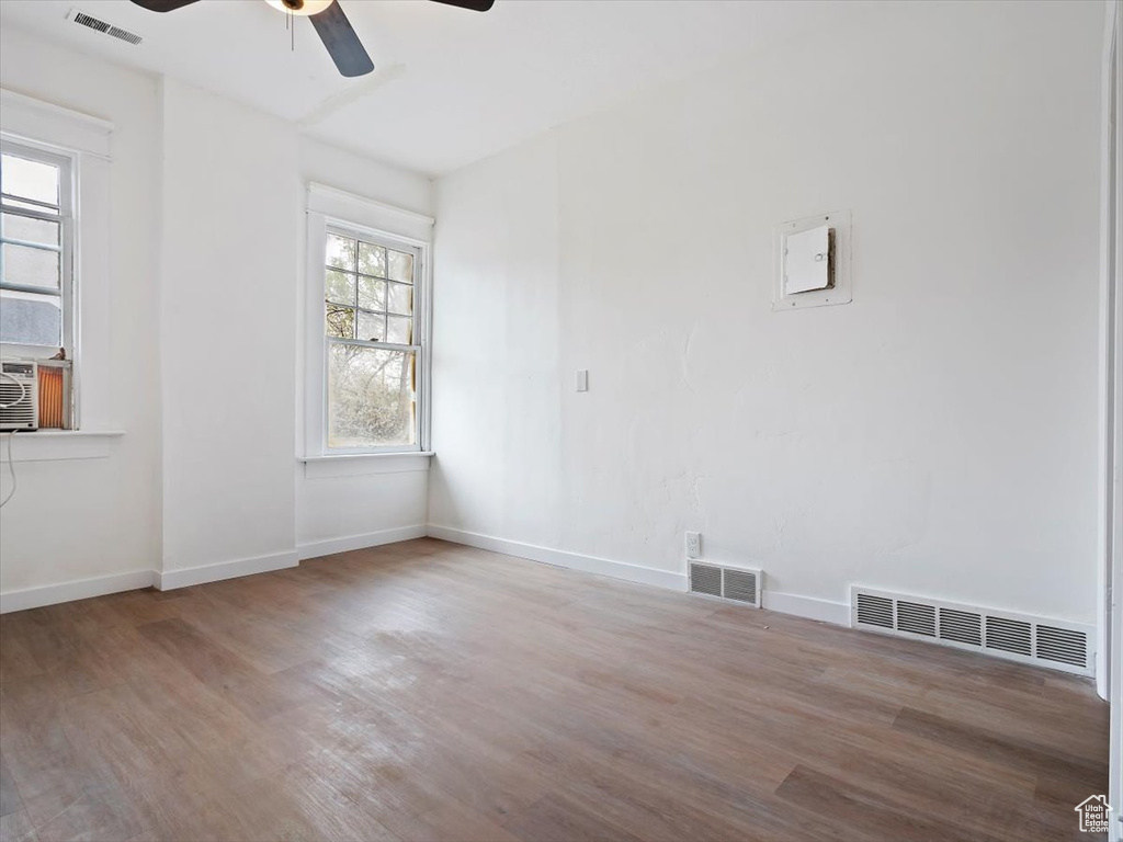 Unfurnished room featuring hardwood / wood-style floors and ceiling fan