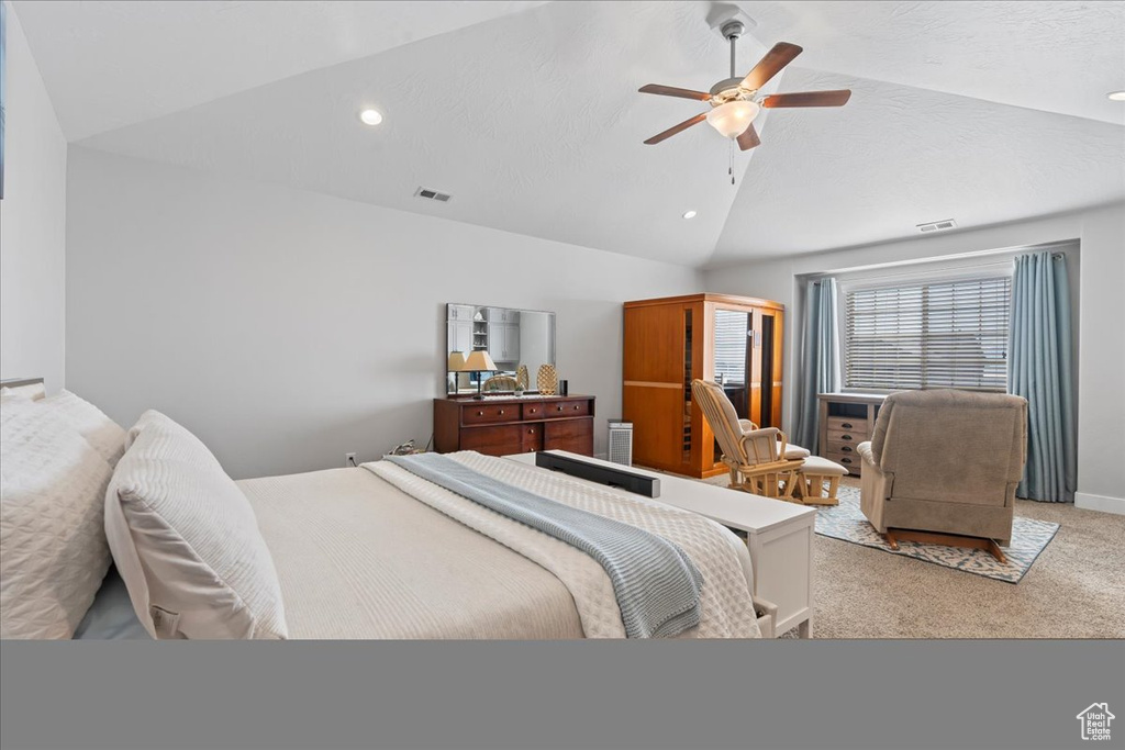 Bedroom featuring light carpet, ceiling fan, and lofted ceiling
