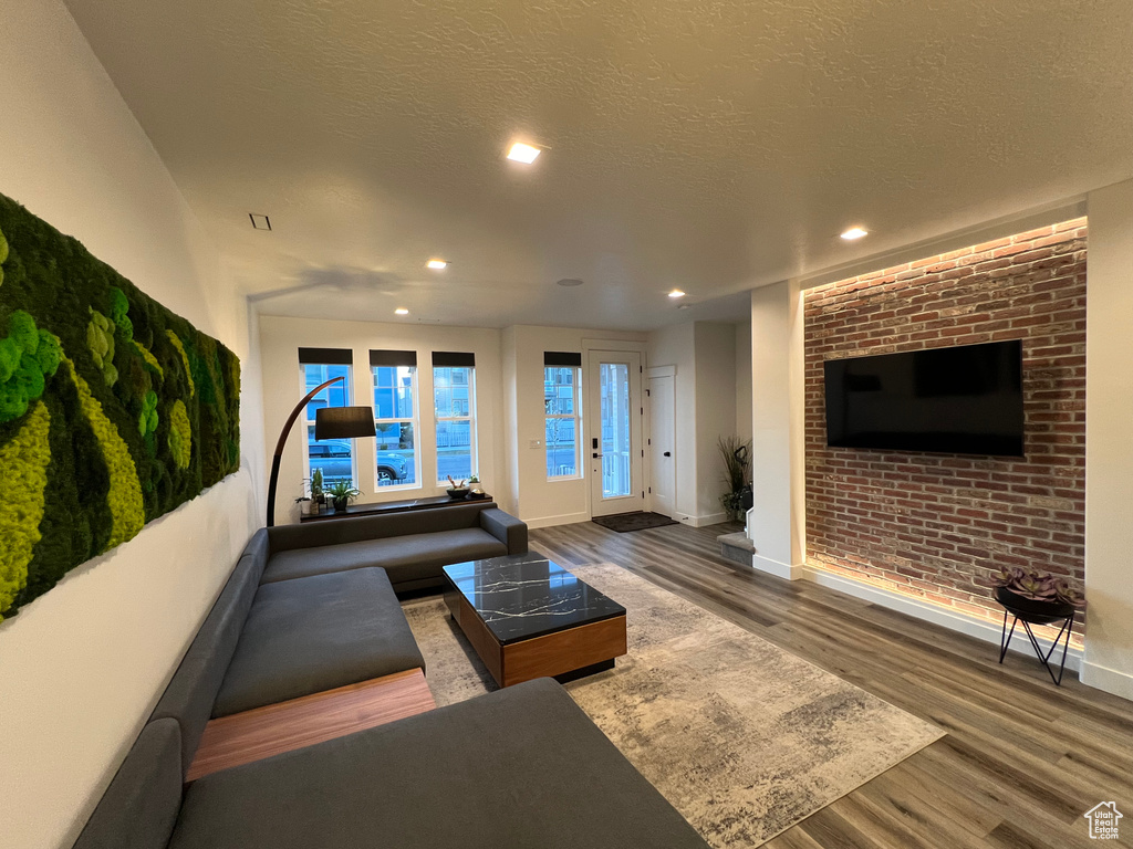 Living room featuring dark hardwood / wood-style floors and a textured ceiling