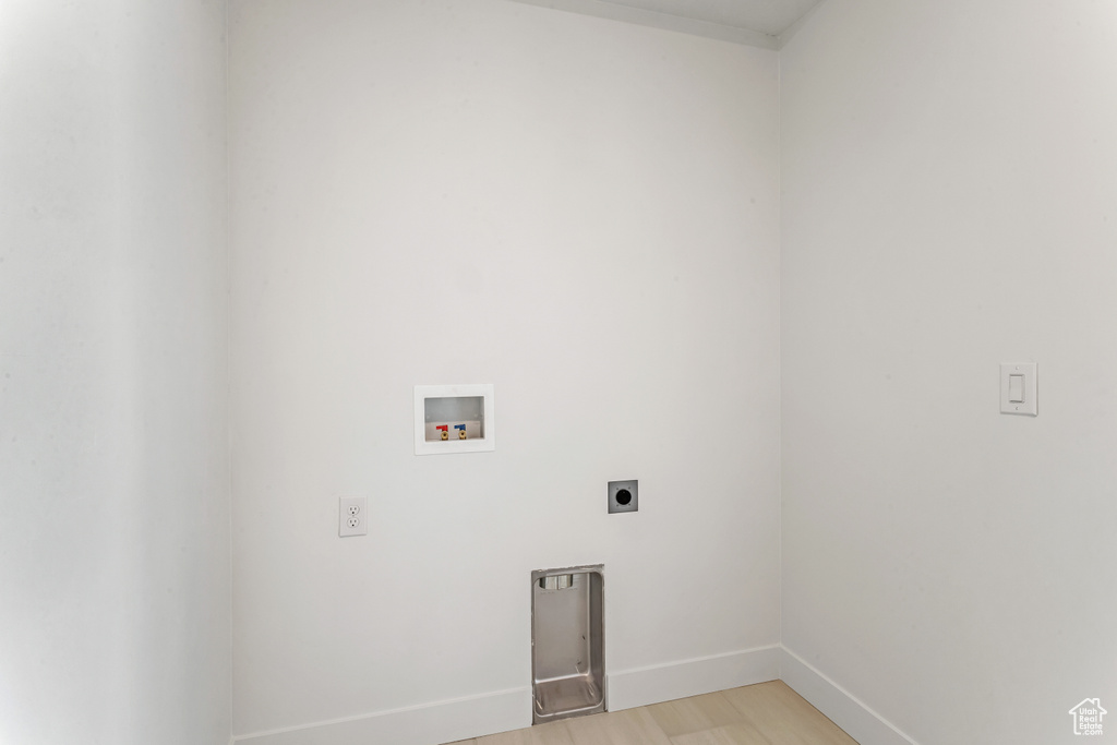 Washroom featuring light hardwood / wood-style flooring, electric dryer hookup, and hookup for a washing machine