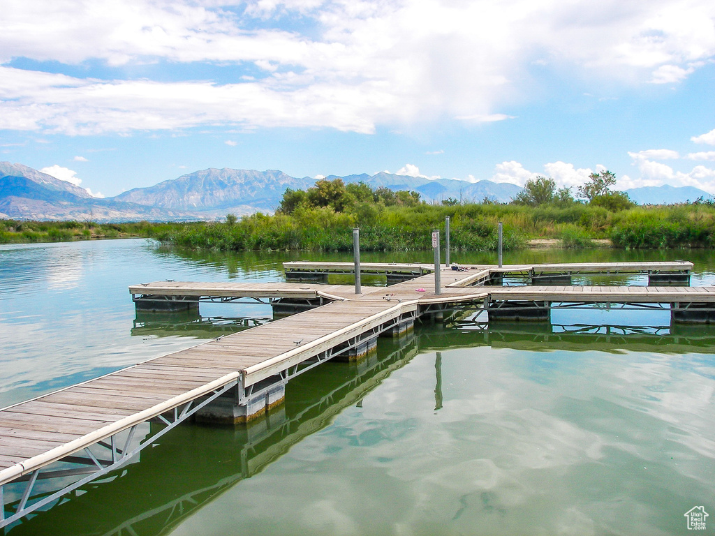 Dock area featuring a water and mountain view