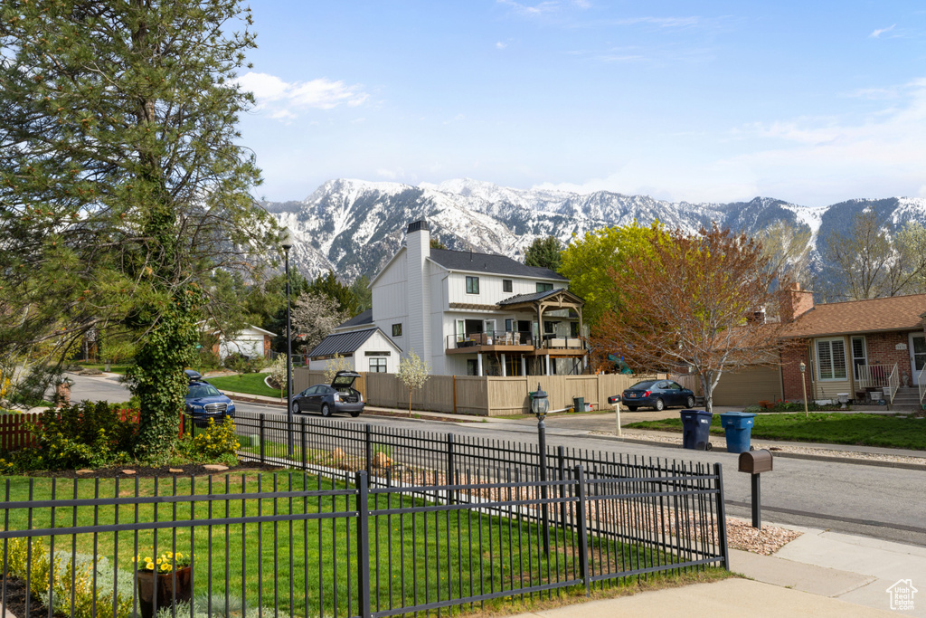 Exterior space featuring a mountain view and a front lawn