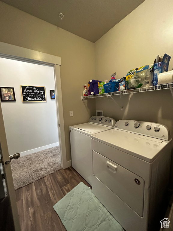 Laundry area featuring dark hardwood / wood-style flooring, washer hookup, and washer and clothes dryer