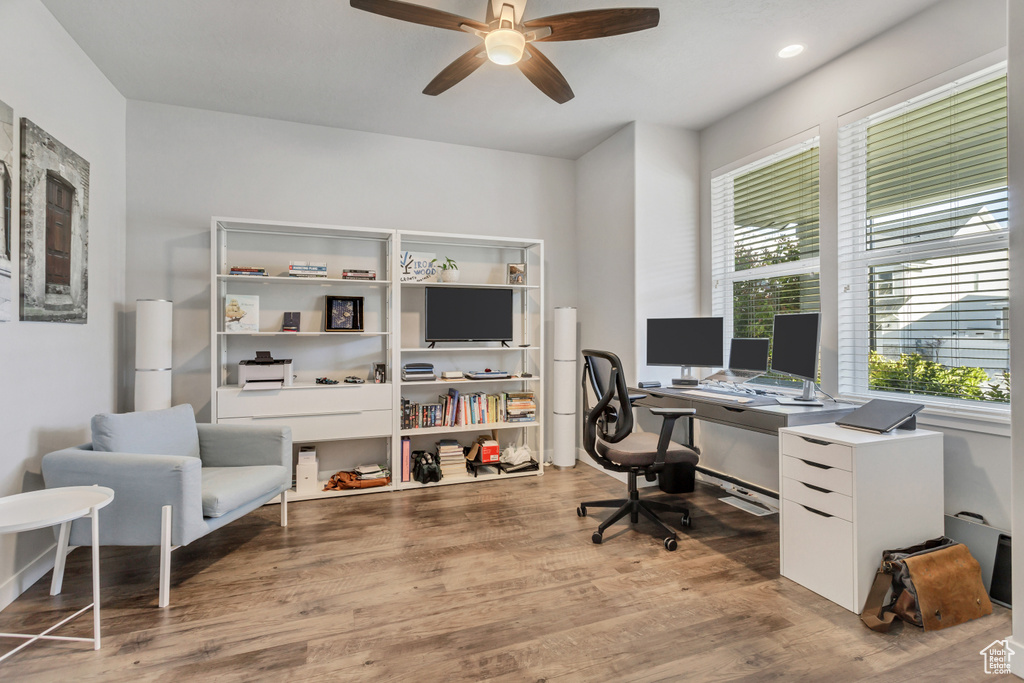 Home office featuring ceiling fan and light hardwood / wood-style floors